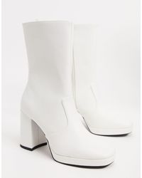 monki zip heeled platform boot in black