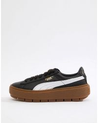 puma platform trace trainers in black with gum sole