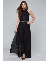 black jumpsuit with skirt overlay