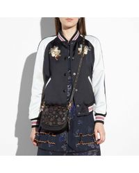 coach tea rose saddle bolsa