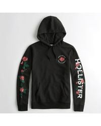 white hollister hoodie with roses
