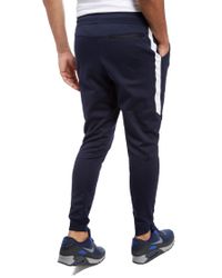 nike tribute track pants blue