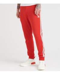 adidas sst track pants mens red