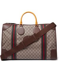 Gucci Leather-trimmed Monogrammed Coated-canvas Duffle Bag in Brown for Men - Lyst
