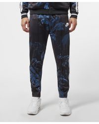 nike sportswear all over print track pants