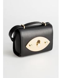 circular push lock crossbody bag