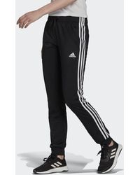 adidas Pantaloni da allenamento Primegreen Essentials Warm-Up Slim Tapered 3-Stripes - Nero