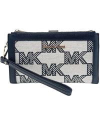 Michael Kors - Jet Set Travel Large Double Zip Wallet Graphic Logo MK Beige Schwarz - Lyst