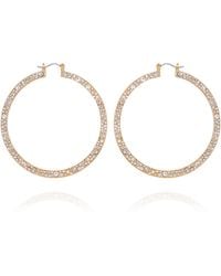 Guess - Orecchini a cerchio con pietra di cristallo dorata - Lyst