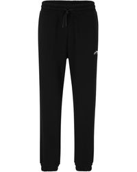 HUGO - Relaxed-fit Cotton Tracksuit Bottoms With Handwritten Logo - Lyst