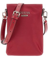 Guess - Sac à épaule bandoulière sac pour téléphone portable Follie Travel Chit Chat Phone Bag Rust Red rouge foncé - Lyst