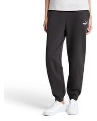 PUMA - Essentials Logo Fleece Sweatpants Black Cuff Leg Ss25 - Lyst