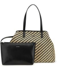 Guess - Schultertasche mit goldenen und schwarzen Streifen - Lyst