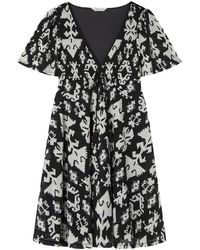Springfield - Vestido Mini Estampado Ikat con Bolitas De Encaje En El Cuello Y Elástico Dentro De La Costura Corto Bicolor - Lyst