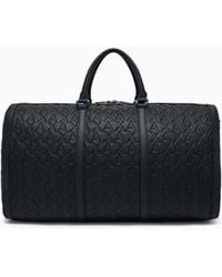 ARMANI EXCHANGE - Duffel Bag With An Embossed Pattern And A Shoulder Strap - Lyst