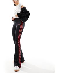 adidas Originals - Leopard luxe - legging évasé à 3 bandes avec imprimé léopard - /rouge - Lyst