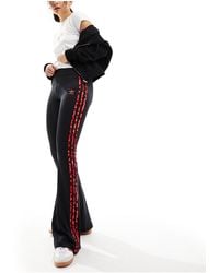 adidas Originals - Leopard luxe - leggings a zampa neri con tre strisce leopardate rosse - Lyst