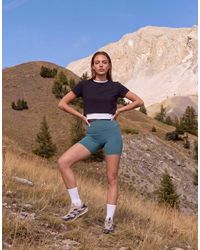 4505 - Icon Active High Waist 5 Inch legging Short With Zip Phone Pocket - Lyst