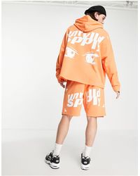 ASOS Sudadera luminoso ultragrande con capucha y estampado del logo con ojos - Naranja