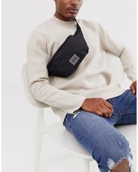 ASOS – Runde, schwarze Gürteltasche zum Umhängen mit Gummiaufnäher