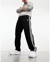 adidas Originals - Firebird - pantaloni sportivi neri - Lyst