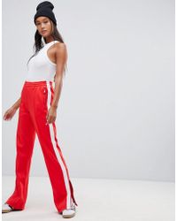 Calvin Klein Pantalones de chndal con rayas en el lateral de Calvin Klein - Rojo