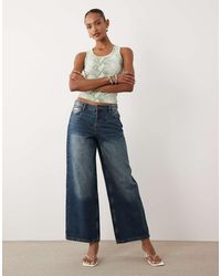 Juicy Couture - Mid Rise Embroidered Crest Logo Wide Leg Jeans - Lyst