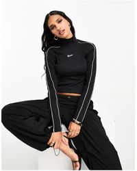Nike - Streetwear - maglietta a maniche lunghe nera con collo a lupetto e righe bianche - Lyst