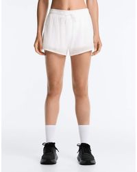 Oysho - Technical Mid Rise 2-in-1 Check Shorts - Lyst
