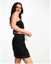 Pieces - Minifalda cargo negra con pespuntes en contraste - Lyst
