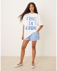 ASOS - Camiseta Color Crema Extragrande Con Estampado Gráfico De Conchas Y Texto "C'Est La Scandal" De -Blanco - Lyst