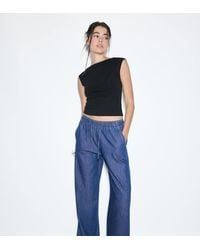 Stradivarius - Petite Flowy Denim Trousers With Drawstring - Lyst