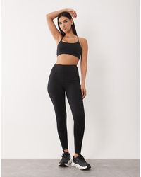 4505 - Hourglass Icon Active Tie Waist Run legging With Phone Pocket - Lyst