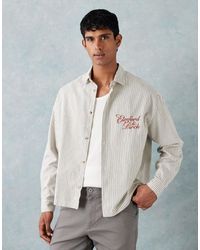 ASOS - Chemise oversize style années 90 coupe carrée à rayures avec imprimé sur le devant - écru - Lyst
