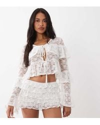 The Frolic - Exclusive Lace Tiered Ruffle Tie Front Top - Lyst