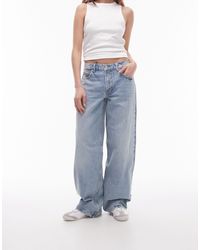 TOPSHOP - Jeans candeggiati a vita bassa con cinturino sul retro - Lyst