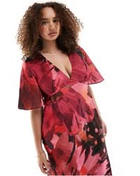 ASOS - Exclusivité - asos design curve - robe mi-longue en satin à manches évasées et grand imprimé floral - rose - Lyst