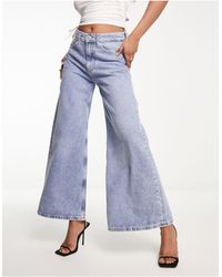 Calvin Klein - Jeans extra larghi con fondo ampio e a vita bassa lavaggio medio - Lyst