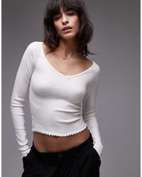 Tommy Hilfiger - Geribbelde Top Met Geschulpte Zoom En Lange Mouwen - Lyst