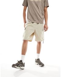 Carhartt - Evers - short cargo en nylon - beige - Lyst