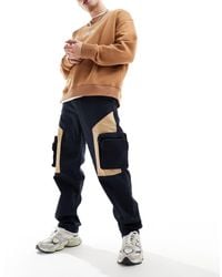 ASOS - Pantalones holgados con bolsillos extragrandes en contraste - Lyst