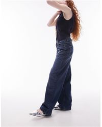 TOPSHOP - Jeans intenso a vita bassa con cinturino sul retro - Lyst