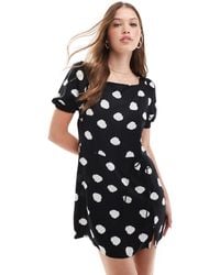 ASOS - Robe t-shirt courte avec manches bouffantes et liens enveloppants à la taille - noir à pois blancs - Lyst