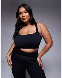 4505 - Curve Seamless Sculpting Medium Support Sports Bra - Lyst