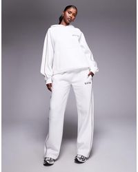 Kaiia - Cotton Rich Side Stripe Embroidered Logo Wide Leg Sweatpants - Lyst