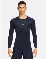 Nike - Nike - pro training - top a maniche lunghe attillato blu navy - Lyst
