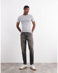 ASOS - Tapered Fit Jeans With Yellow Tint - Lyst