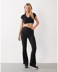 4505 - Leggings A Zampa Da Yoga Slim A Vita Alta Neri A Costine Con Spacco Laterale - Lyst
