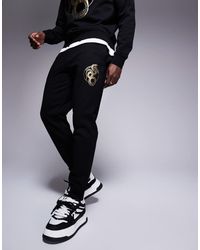 ARMANI EXCHANGE - Lunar Capsule Snake joggers - Lyst