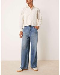 ASOS - Vaqueros Muy Holgados Con Lavado Azul Medio Y Bordado En Los Bolsillos Traseros De - Lyst